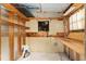 Unfinished storage area with exposed framing, shelving, and some materials, perfect for customization at 10012 Sw 88Th Ct, Ocala, FL 34481