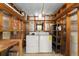 Functional utility room with washer, dryer, shelving, and exposed framing at 10012 Sw 88Th Ct, Ocala, FL 34481