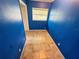 Small bedroom with blue walls, light-colored tile flooring and one window at 1051 Se 28Th Rd, Ocala, FL 34471