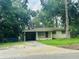 Modest single-story home featuring a covered carport and small front lawn at 1051 Se 28Th Rd, Ocala, FL 34471
