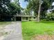View of exterior including front yard, driveway, and carport at 1051 Se 28Th Rd, Ocala, FL 34471