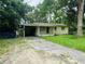 View of exterior including front yard, driveway, and carport at 1051 Se 28Th Rd, Ocala, FL 34471