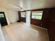 Versatile living space with wood-paneled walls, a ceiling fan, and natural light at 1051 Se 28Th Rd, Ocala, FL 34471