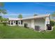 Expansive backyard showcasing well-kept lawn, siding, and access to a charming sunroom at 10806 Sw 86Th Ave, Ocala, FL 34481