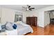 Comfortable bedroom with hardwood floors, ceiling fan, and large windows at 10806 Sw 86Th Ave, Ocala, FL 34481