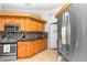 Well-lit kitchen with wooden cabinets, stainless steel appliances, and stylish backsplash at 10806 Sw 86Th Ave, Ocala, FL 34481
