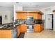 Charming kitchen featuring wooden cabinets, granite countertops, and stainless steel appliances at 10806 Sw 86Th Ave, Ocala, FL 34481
