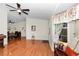 Comfortable living room showcasing hardwood floors and an open layout to the dining area at 10806 Sw 86Th Ave, Ocala, FL 34481