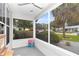 Enclosed patio area providing a relaxing outdoor space with views of the landscaped yard and neighborhood at 10806 Sw 86Th Ave, Ocala, FL 34481