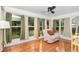 Inviting sunroom filled with natural light and featuring neutral decor and a view of the backyard at 10806 Sw 86Th Ave, Ocala, FL 34481