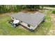 Aerial view of the home's backyard showing patio with seating, open grassy areas, and surrounding woods at 13131 Sw 73Rd St, Ocala, FL 34481
