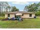 Expansive backyard featuring a patio area with umbrella-covered seating, and plenty of open grassy space at 13131 Sw 73Rd St, Ocala, FL 34481