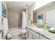 Bathroom featuring tub and shower with gray tile surround, granite countertops, and sleek vanity at 13131 Sw 73Rd St, Ocala, FL 34481