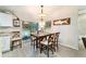 Cozy dining area with stylish light fixture, a decorative shark wall hanging, and sliding glass door access at 13131 Sw 73Rd St, Ocala, FL 34481
