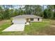 Charming home showcasing a well-manicured front lawn, paved driveway, and inviting exterior at 13131 Sw 73Rd St, Ocala, FL 34481