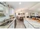 Bright kitchen featuring stainless steel appliances and granite countertops open to a dining and living area at 13131 Sw 73Rd St, Ocala, FL 34481