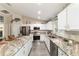 Bright kitchen with marble countertops, white cabinets, and stainless steel appliances at 13131 Sw 73Rd St, Ocala, FL 34481