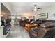 Open concept living room with gray flooring, a ceiling fan, and modern furniture at 13131 Sw 73Rd St, Ocala, FL 34481