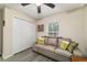 Living area featuring a couch, wood floors, ceiling fan, closet, and is lit by a large window at 13131 Sw 73Rd St, Ocala, FL 34481
