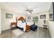 Bright and airy main bedroom featuring a large bed with wood frame, ceiling fan, and natural light at 13131 Sw 73Rd St, Ocala, FL 34481