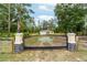 Elegant gated entrance featuring decorative pillars and a charming fish emblem, adding a unique touch at 13131 Sw 73Rd St, Ocala, FL 34481