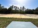 Large backyard area with trees in the distance, providing a sense of privacy at 1390 Sw Obee Ridge Rd, Dunnellon, FL 34431
