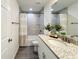Cozy bathroom with vanity, granite countertop, tub-shower and decorative shower curtain at 1390 Sw Obee Ridge Rd, Dunnellon, FL 34431