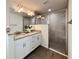 Elegant bathroom featuring a double vanity, granite counters, and a glass-enclosed shower at 1390 Sw Obee Ridge Rd, Dunnellon, FL 34431