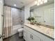 Bright bathroom features a tub-shower combo with decorative tiling and a granite-topped vanity at 1390 Sw Obee Ridge Rd, Dunnellon, FL 34431