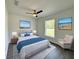 Relaxing bedroom with a large bed, blue accents, beach-themed artwork and window at 1390 Sw Obee Ridge Rd, Dunnellon, FL 34431