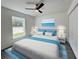 Bright bedroom boasts natural light, ceiling fan, and a view of the yard and closet at 1390 Sw Obee Ridge Rd, Dunnellon, FL 34431
