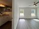 Cozy bedroom with wood-look flooring, bright windows, and a partial view of an en-suite bathroom at 1390 Sw Obee Ridge Rd, Dunnellon, FL 34431