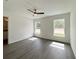 Bedroom bathed in sunlight, featuring wood-look floors and two windows providing an inviting space at 1390 Sw Obee Ridge Rd, Dunnellon, FL 34431