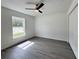 Bright bedroom boasts natural light, ceiling fan, and a view of the yard and closet at 1390 Sw Obee Ridge Rd, Dunnellon, FL 34431