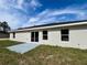 Back exterior view of home featuring sliding glass doors leading to the backyard at 1390 Sw Obee Ridge Rd, Dunnellon, FL 34431