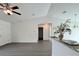 Inviting living room featuring a vaulted ceiling, gray floors and seamless transition to the kitchen at 1390 Sw Obee Ridge Rd, Dunnellon, FL 34431