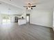 Open living area with modern gray floors overlooking the kitchen and breakfast nook at 1390 Sw Obee Ridge Rd, Dunnellon, FL 34431