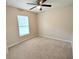 Bedroom boasts neutral carpet, a ceiling fan, and a window for plenty of natural light at 13921 Sw 108Th Ln, Dunnellon, FL 34432