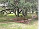 Charming wooden bridge surrounded by mature trees with Spanish moss, in a serene setting at 13921 Sw 108Th Ln, Dunnellon, FL 34432