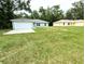 Lovely single-story home with an attached two-car garage and a spacious green lawn at 13921 Sw 108Th Ln, Dunnellon, FL 34432