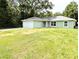 Inviting single-story home featuring a well-manicured lawn and an attached two-car garage at 13921 Sw 108Th Ln, Dunnellon, FL 34432