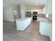 Contemporary kitchen with white cabinets, stainless steel appliances, and a functional center island at 13921 Sw 108Th Ln, Dunnellon, FL 34432