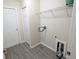 Laundry room featuring hard floors, a shelf and access to washer and dryer hook-ups at 13921 Sw 108Th Ln, Dunnellon, FL 34432