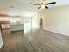 Open-concept living area with hardwood floors, bright kitchen, and sliding glass doors at 13921 Sw 108Th Ln, Dunnellon, FL 34432