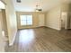 Bright, open-concept living area with hardwood floors and large windows, creating a warm and inviting space at 13921 Sw 108Th Ln, Dunnellon, FL 34432