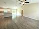 Spacious open-concept living area featuring new hardwood floors and a modern ceiling fan at 13921 Sw 108Th Ln, Dunnellon, FL 34432