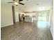 Open-concept living area with hardwood floors, white kitchen, stainless appliances and sliding glass doors at 13921 Sw 108Th Ln, Dunnellon, FL 34432