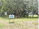 Welcoming sign for Lake Otting surrounded by beautiful mature trees and lush greenery at 13921 Sw 108Th Ln, Dunnellon, FL 34432
