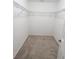 A practical walk-in closet with wire shelving and neutral carpet for organized storage at 13921 Sw 108Th Ln, Dunnellon, FL 34432