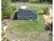 Aerial view of the backyard with a grassy area and a sliding glass door entrance at 142 Guava Pass, Ocklawaha, FL 32179